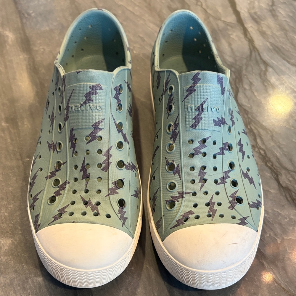 Native army green Slip-On Shoes with lightning bolts.